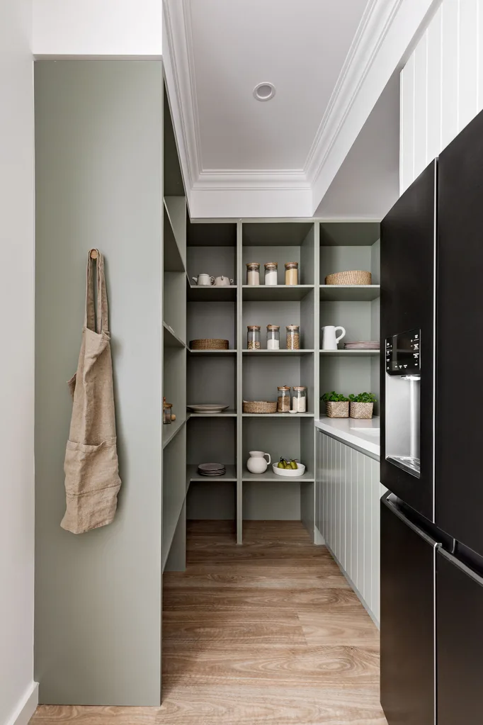 A modern butler's pantry with sage green shelving