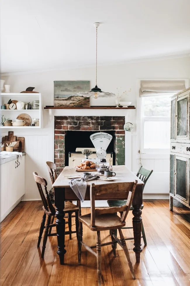A rustic kitchen with a wooden dining table