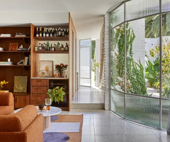 mid-century-inspired new home with curved glass windows and walnut timber joinery