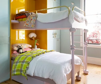 Joyful design meets clever functionality in this bedroom built for three