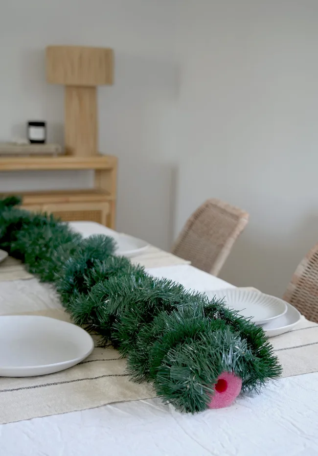 pool noodle covered in tinsel on a dining table